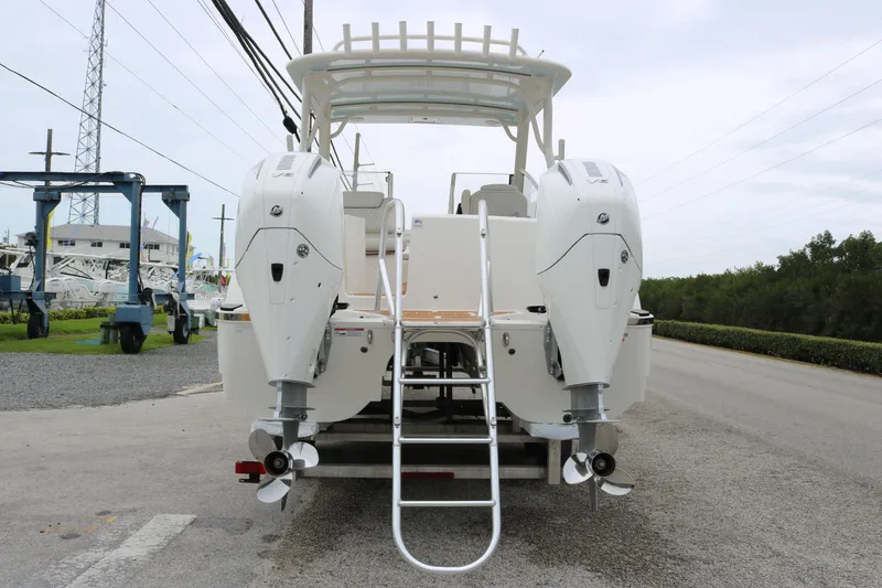 Slide: The Image of 2024 World Cat 280 DC-X boat with dual outboard engines and rear ladder. - 6