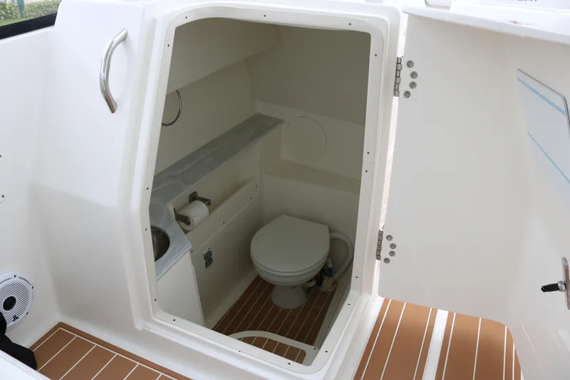 Slide: The Image of 2024 World Cat 280 DC-X boat interior with compact bathroom and toilet. - 9