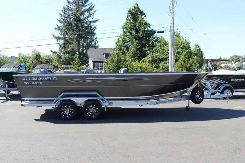 The Image of 2025 Alumaweld Columbia 23 boat on trailer, parked outdoors. - 1
