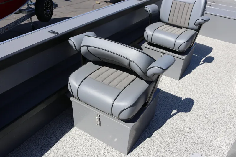 Slide: The Image of 2025 Alumaweld Columbia 23 boat seats with gray upholstery and storage compartments. - 13