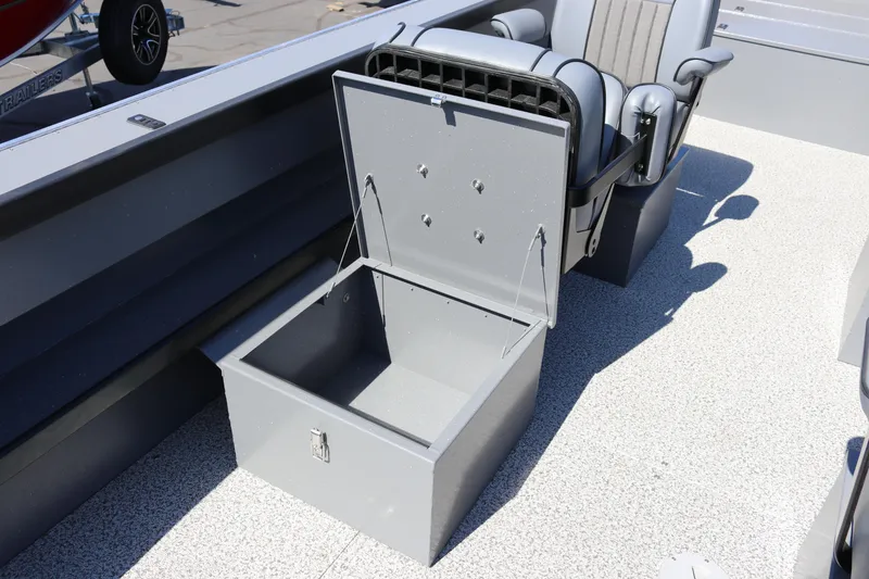 Slide: The Image of 2025 Alumaweld Columbia 23 boat interior with open storage compartment and seating. - 14