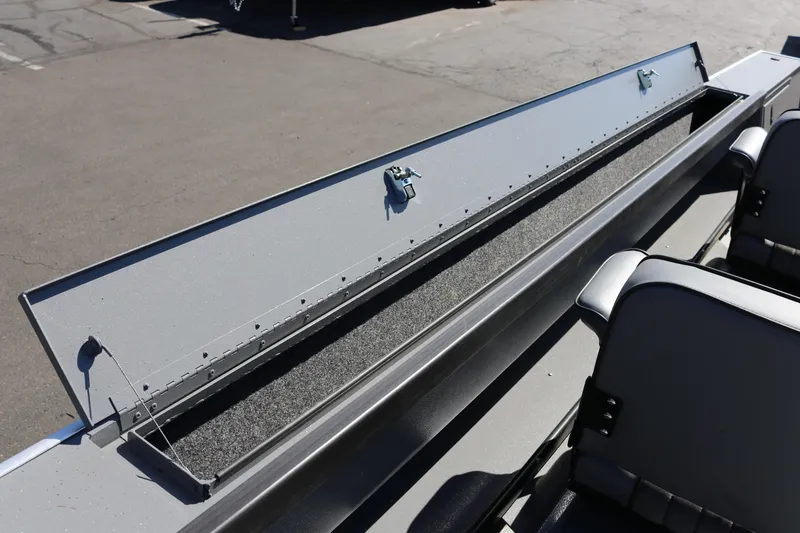 Slide: The Image of 2025 Alumaweld Columbia 23 boat storage compartment with open lid and secure latches. - 18