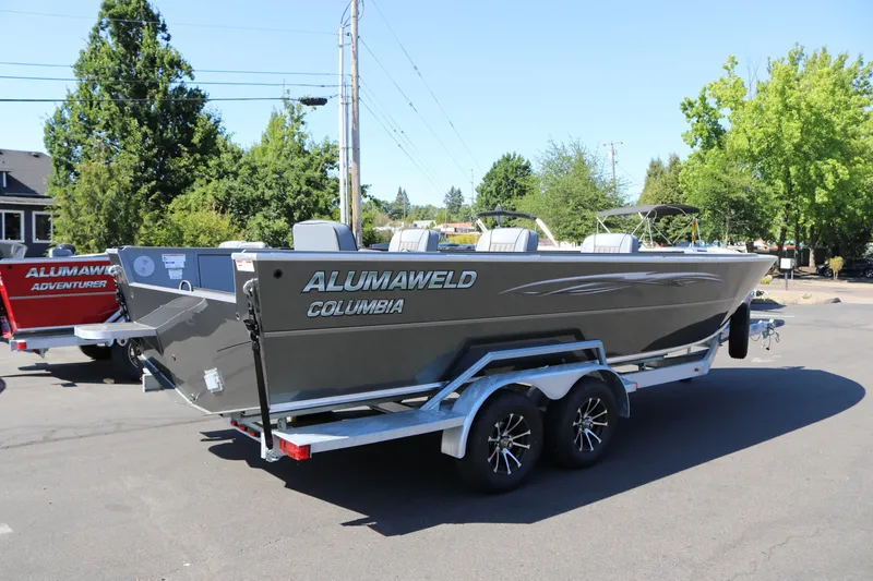Slide: The Image of 2025 Alumaweld Columbia 23 boat on trailer, parked outdoors on a sunny day. - 31