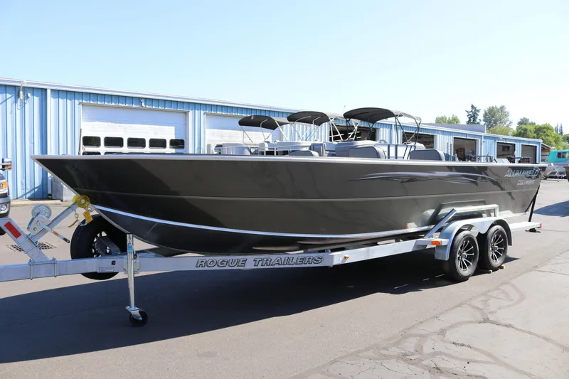 Slide: The Image of 2025 Alumaweld Columbia 23 boat on Rogue Trailers, parked outside industrial building. - 34