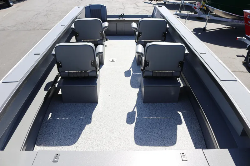 Slide: The Image of 2025 Alumaweld Columbia 23 boat interior with four gray seats on a speckled deck. - 4