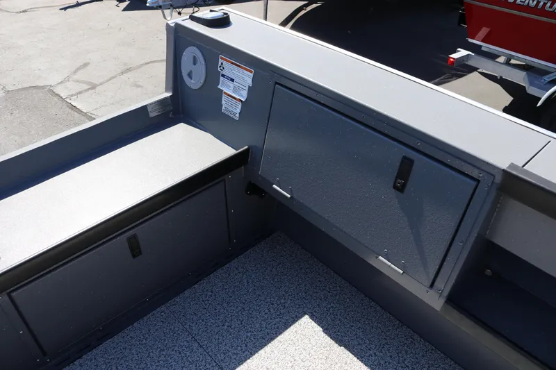 Slide: The Image of Interior view of 2025 Alumaweld Columbia 23 boat, featuring storage compartments and non-slip flooring. - 7