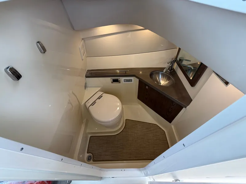 Slide: The Image of Interior of 2026 Chris-Craft Calypso 32 with toilet and sink. - 22