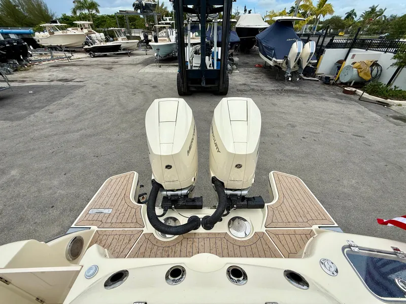 Slide: The Image of Rear view of a 2026 Chris-Craft Calypso 32 with twin outboard engines. - 24