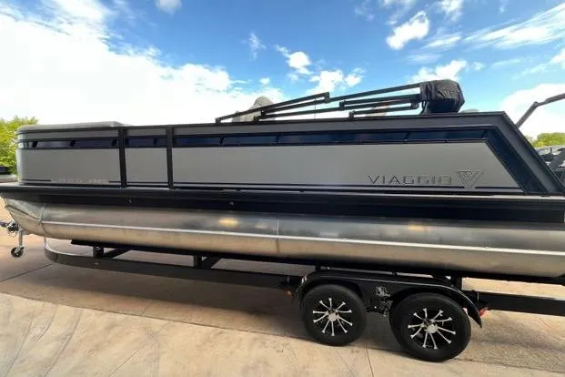 The Image of 2024 Viaggio Lago X 22 Q pontoon boat on trailer under blue sky. - 0