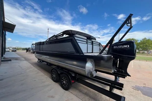 Slide: The Image of 2024 Viaggio LAgo X 22 Q pontoon boat with Suzuki engine on trailer. - 2