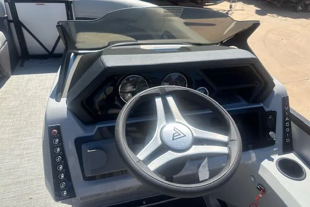 Slide: The Image of 2024 Viaggio LAgo X 22 Q boat dashboard with steering wheel and control panel. - 4