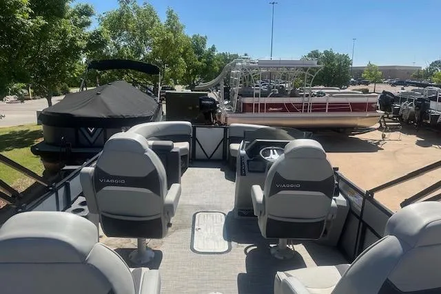 Slide: The Image of 2024 Viaggio LAgo X 22 Q pontoon boat interior with seating and steering console. - 6