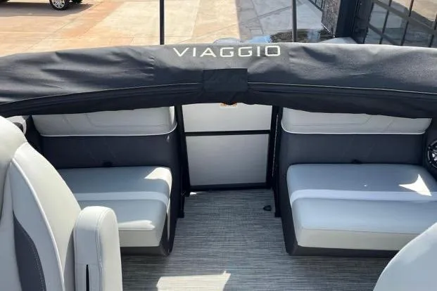 Slide: The Image of 2024 Viaggio Lago X 22 Q boat interior with seating and Viaggio branding. - 7