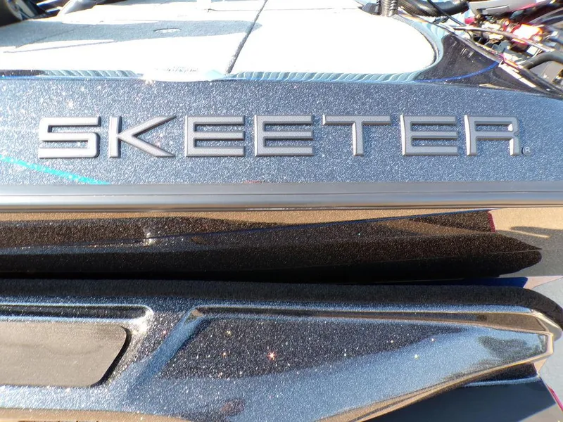 Slide: The Image of Close-up of 2025 Skeeter FXR20L boat logo with metallic finish. - 10