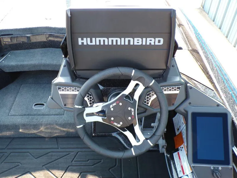 Slide: The Image of 2025 Skeeter FXR20L boat dashboard with Humminbird display and steering wheel. - 13