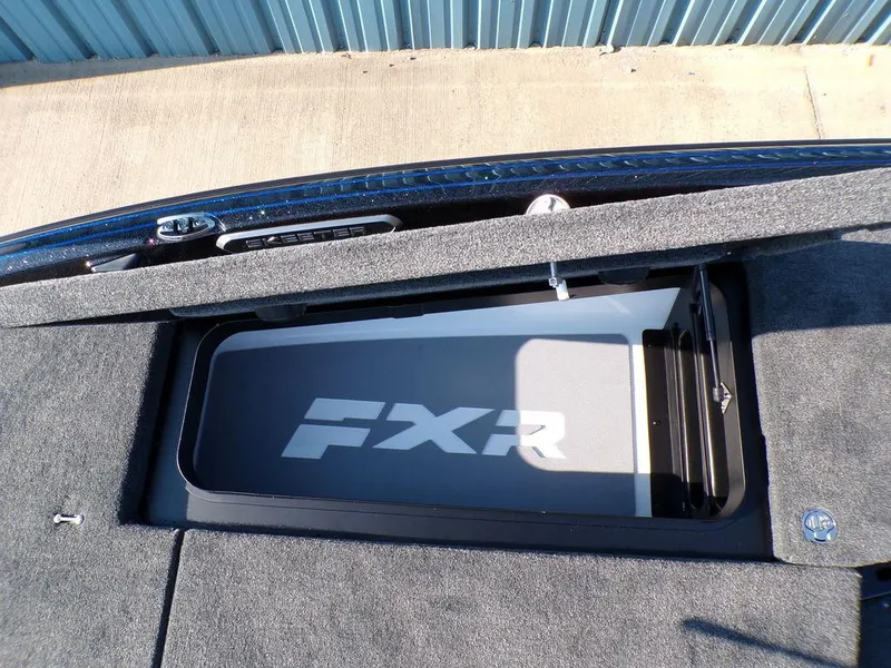 Slide: The Image of 2025 Skeeter FXR20L boat storage compartment with FXR branding. - 18