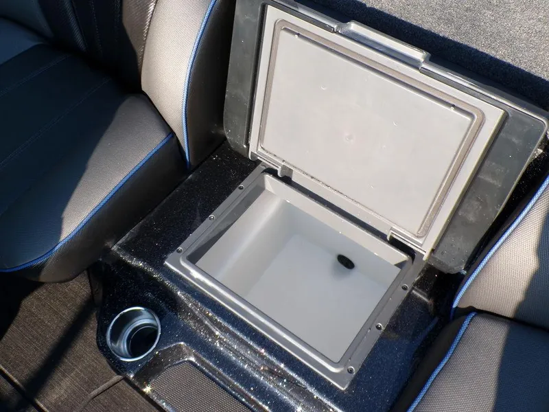 Slide: The Image of 2025 Skeeter FXR20L boat storage compartment with cup holder, open lid. - 23