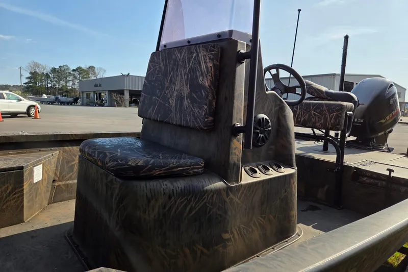 Slide: The Image of 2019 G3 Bay 20 DLX Camo boat with camo seating and Yamaha motor in parking lot. - 10