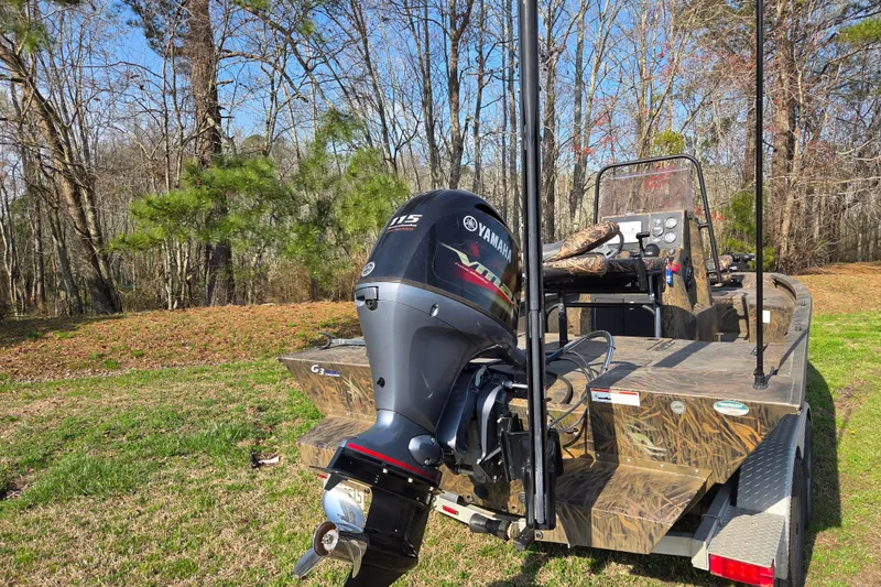 Slide: The Image of 2019 G3 Bay 20 DLX Camo boat with Yamaha motor in wooded area. - 3