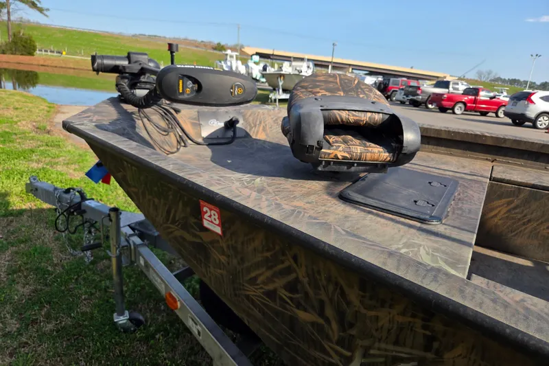 Slide: The Image of 2019 G3 Bay 20 DLX Camo boat on trailer, parked near a pond. - 9