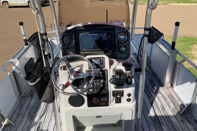 Slide: The Image of 2019 Angler Quest 826 CRAPPIE boat dashboard with steering wheel and navigation equipment. - 6