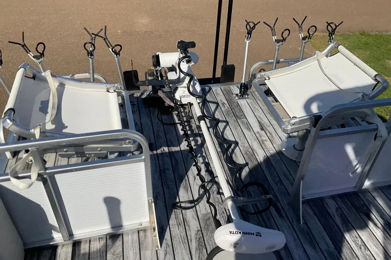 Slide: The Image of 2019 Angler Quest 826 CRAPPIE boat deck with fishing rod holders and seating. - 7