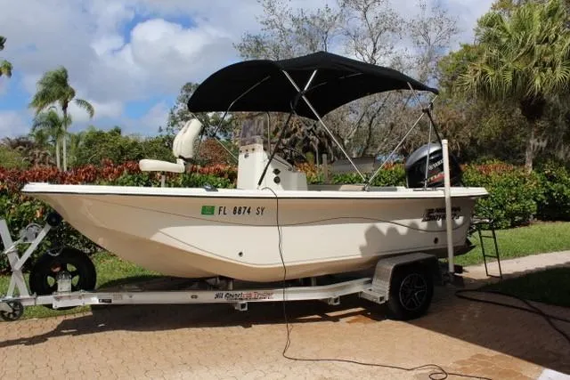 The Image of 2021 Carolina Skiff 17 LS boat on trailer with canopy, parked outdoors. - 0