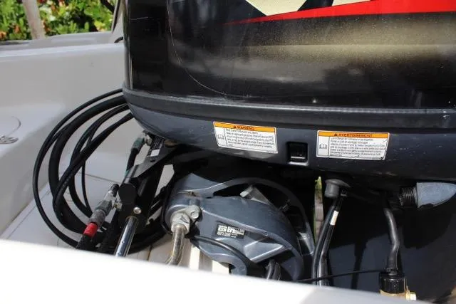 Slide: The Image of 2021 Carolina Skiff 17 LS boat engine with visible cables and warning labels. - 8