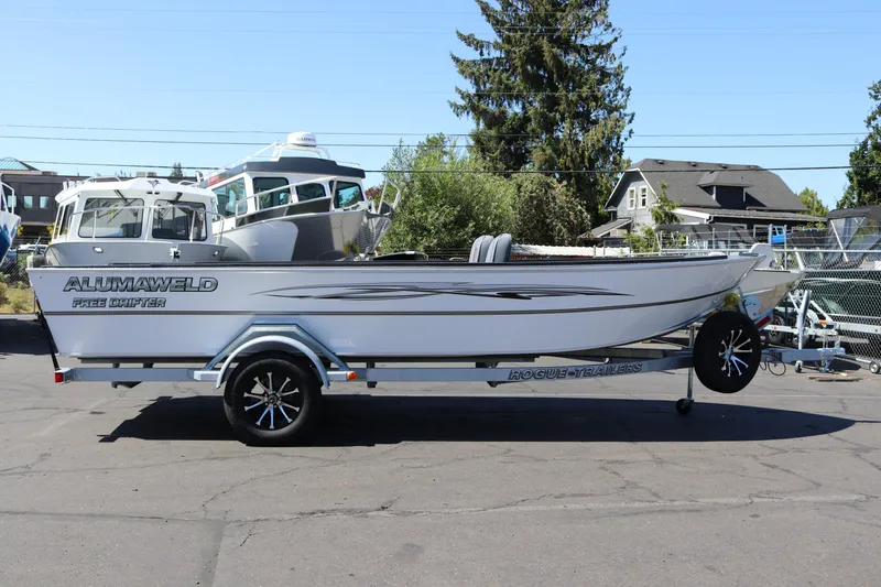 The Image of 2025 Alumaweld Free Drifter 20 boat on trailer, parked outdoors. - 1
