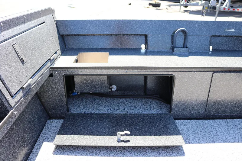 Slide: The Image of 2025 Alumaweld Free Drifter 20 boat interior with storage compartments and textured flooring. - 23