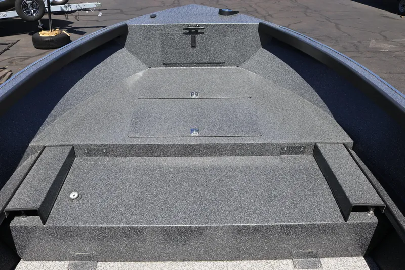 Slide: The Image of 2025 Alumaweld Free Drifter 20 boat interior with spacious, textured deck and storage compartments. - 8