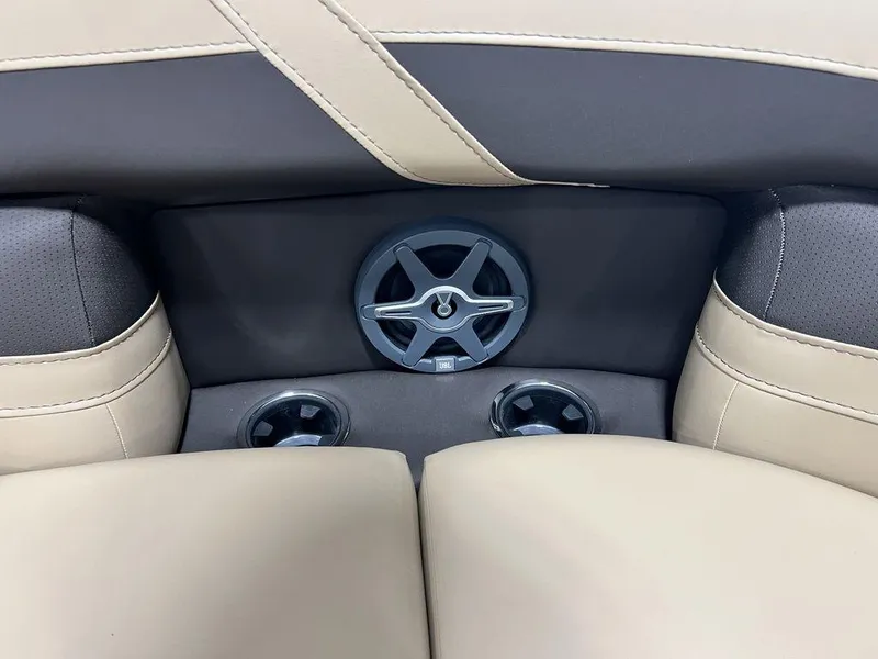 Slide: The Image of Barletta CABRIO C24UC 2025 boat interior with beige and black seating and cup holders. - 13