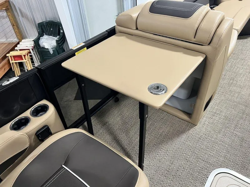 Slide: The Image of 2025 Barletta CABRIO C24UC boat interior with beige seating and foldable table. - 16