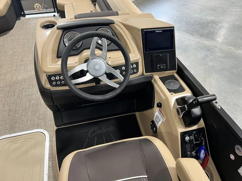 Slide: The Image of 2025 Barletta Cabrio C24UC boat dashboard with steering wheel and control panel. - 18