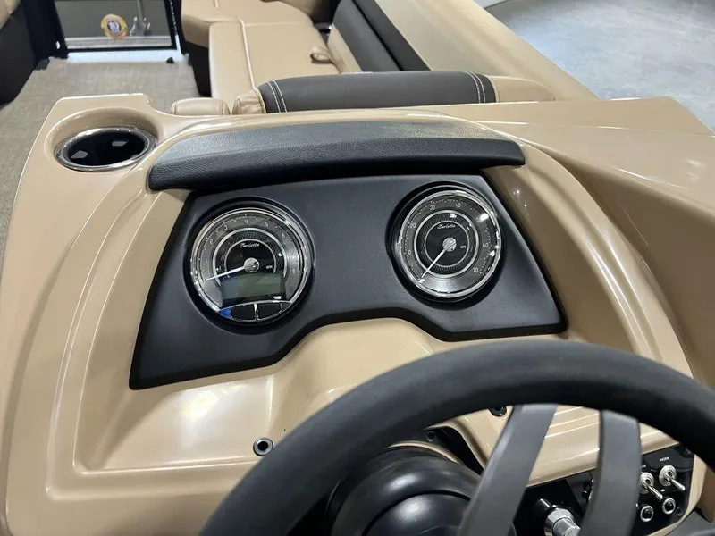 Slide: The Image of Dashboard of 2025 Barletta Cabrio C24UC pontoon boat with gauges and steering wheel. - 25