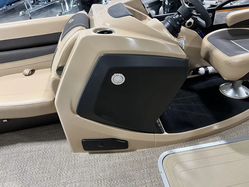 Slide: The Image of 2025 Barletta CABRIO C24UC boat interior, beige and black seating, steering console. - 27