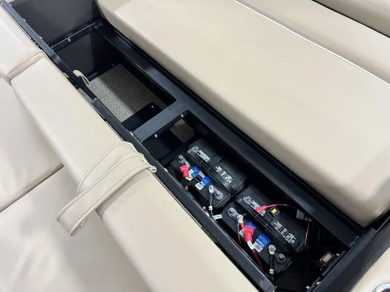 Slide: The Image of 2025 Barletta CABRIO C24UC boat battery compartment under beige seating. - 28