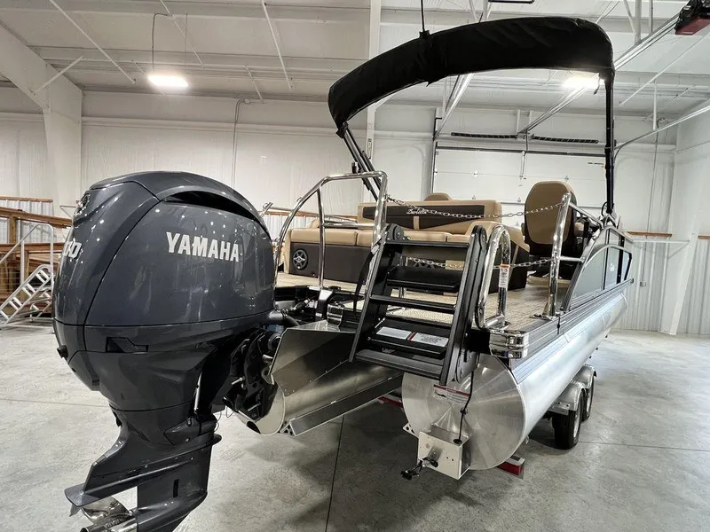 Slide: The Image of 2025 Barletta CABRIO C24UC pontoon boat with Yamaha outboard motor in a showroom. - 9