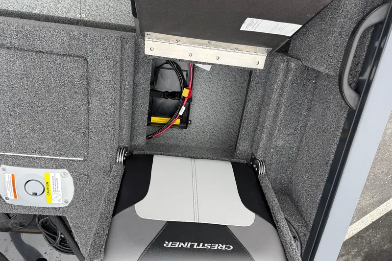 Slide: The Image of 2026 Crestliner 1750 Hawk boat interior with storage compartment and battery setup. - 15