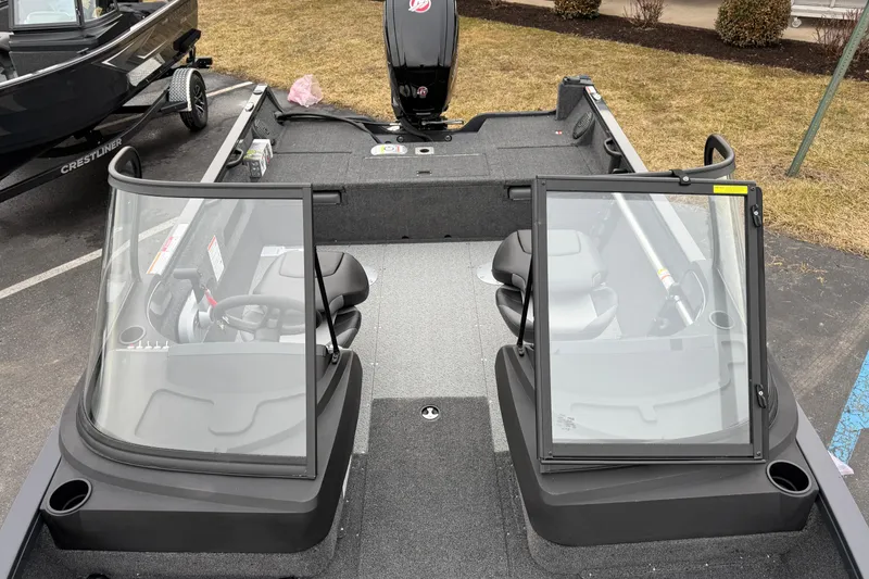 Slide: The Image of 2026 Crestliner 1750 Hawk boat interior with dual windshields and seating. - 5