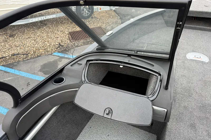 Slide: The Image of 2026 Crestliner 1750 Hawk boat interior with open storage compartment and windshield. - 8