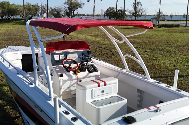 Slide: The Image of 1992 Baja 280 Sportfish boat with red canopy and modern navigation equipment. - 6