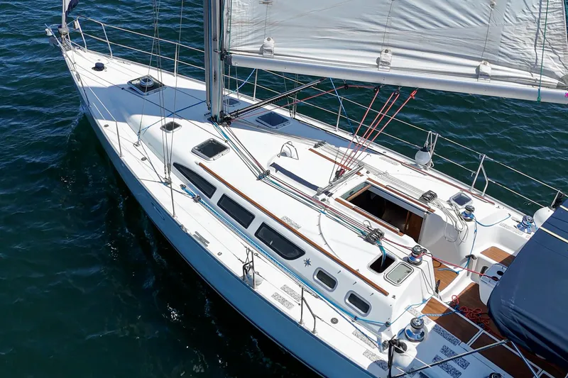 Slide: The Image of Jeanneau Sun Odyssey 43 sailboat from 2002 on open water, showcasing sleek design and sails. - 17