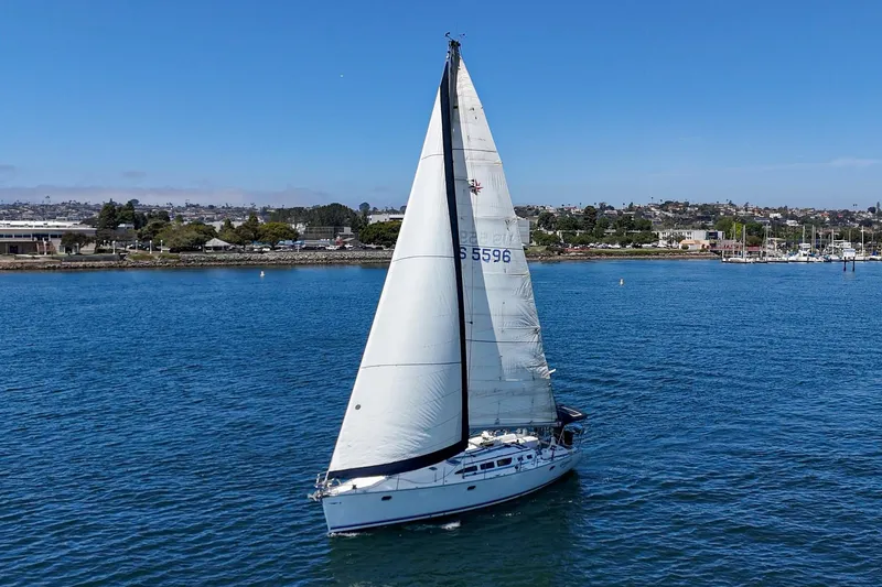 Slide: The Image of 2002 Jeanneau Sun Odyssey 43 sailing on calm blue waters. - 2