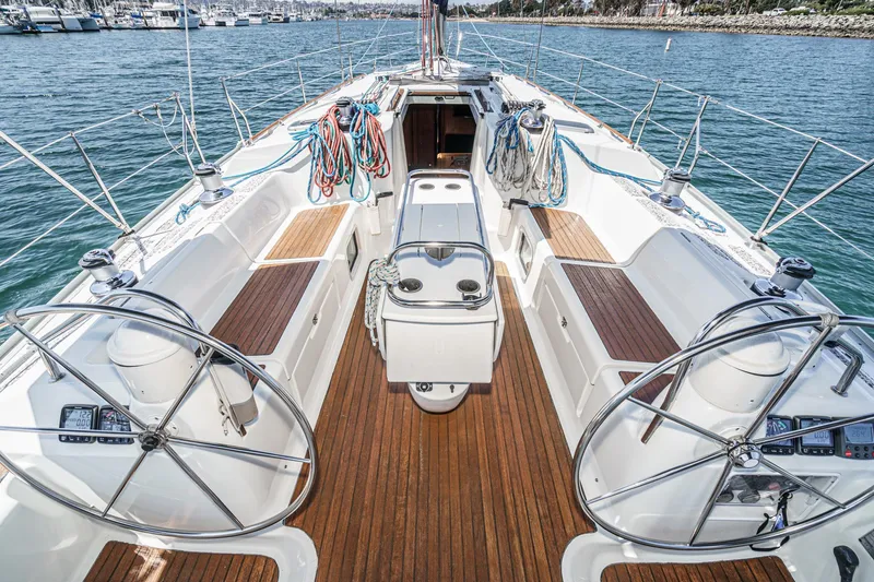 Slide: The Image of Jeanneau Sun Odyssey 43 sailboat cockpit, 2002 model, with dual steering wheels and teak decking. - 23
