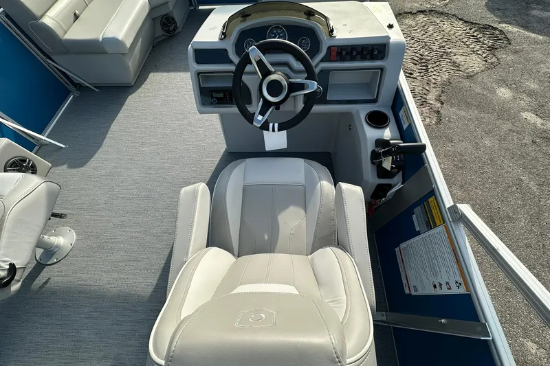 Slide: The Image of Captain's seat and helm of 2026 Sweetwater EX 2286 SFLX pontoon boat. - 14