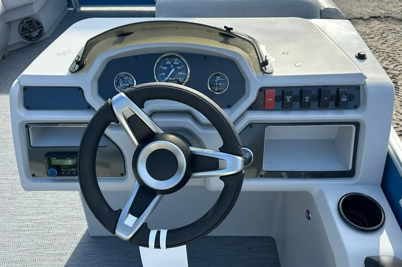 Slide: The Image of Steering console of 2026 Sweetwater EX 2286 SFLX boat with gauges and controls. - 15
