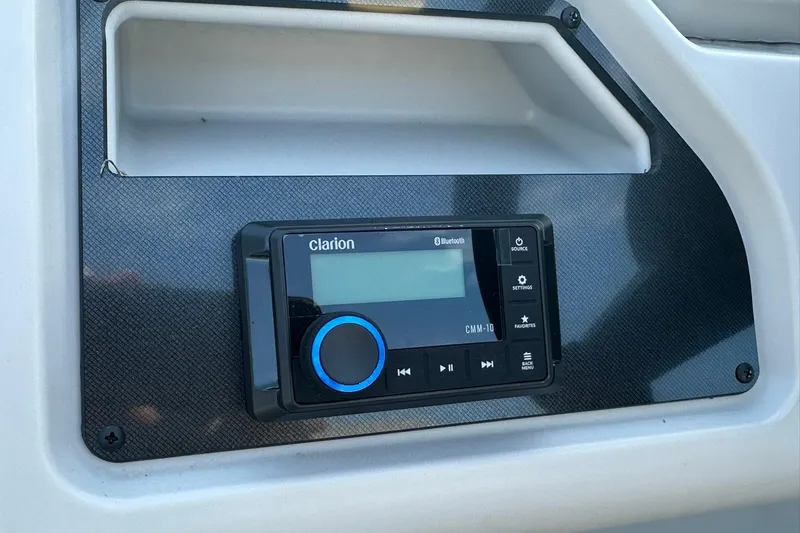 Slide: The Image of Clarion Bluetooth stereo system in 2026 Sweetwater EX 2286 SFLX boat dashboard. - 17