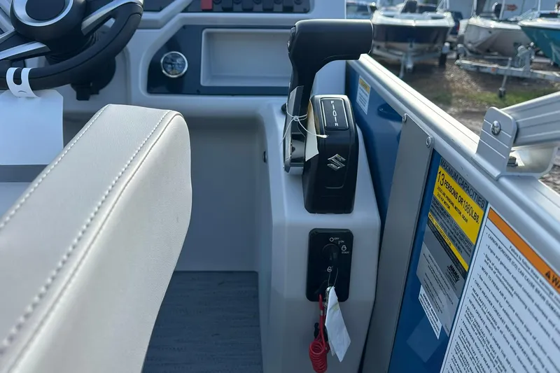 Slide: The Image of Interior view of 2026 Sweetwater EX 2286 SFLX boat cockpit controls. - 19