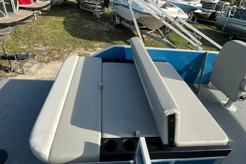 Slide: The Image of 2026 Sweetwater EX 2286 SFLX boat with cushioned seating and cup holders. - 23